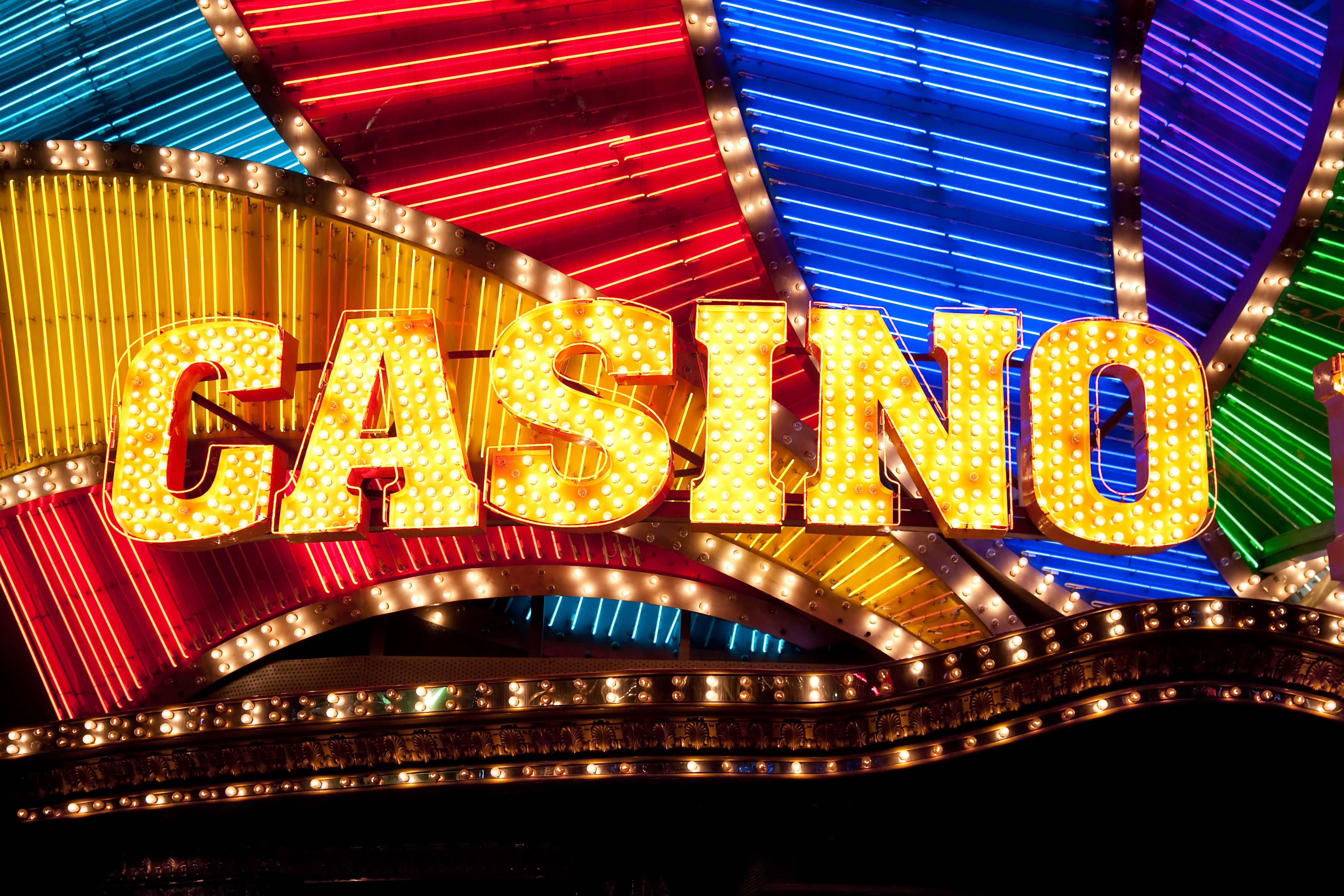 A dynamic graphic showing a variety of casino elements like a roulette wheel, slot machine, and poker chips.